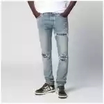 AMIRI MX1 distressed flannel-patched jeans in medium indigo