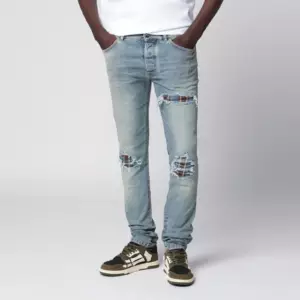 AMIRI MX1 distressed flannel-patched jeans in medium indigo
