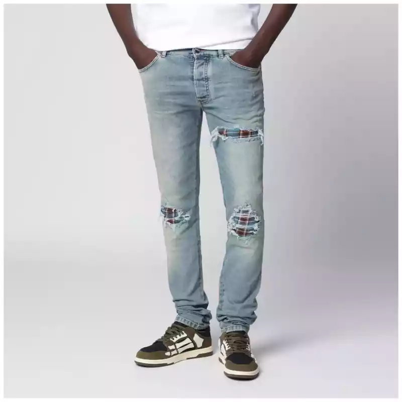 AMIRI MX1 distressed flannel-patched jeans in medium indigo