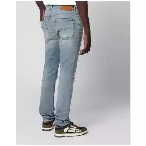 AMIRI MX1 distressed flannel-patched jeans in medium indigo